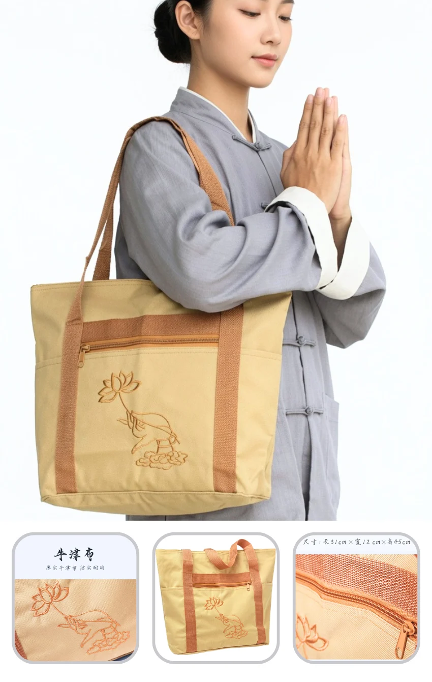 tui-hanh-huong-di-chua 1 Woman in a gray traditional outfit carries a beige tote bag with brown straps and a lotus embroidery design.