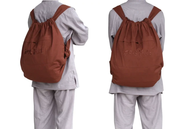 ba-lo-di-chua-mau-nau - Pháp Phục Thiền Pháp Phục Two angles of a rust brown drawstring backpack worn over a gray outfit