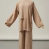 Beige loose-fit tunic with wide sleeves and matching wide-leg pants on a dress form.
