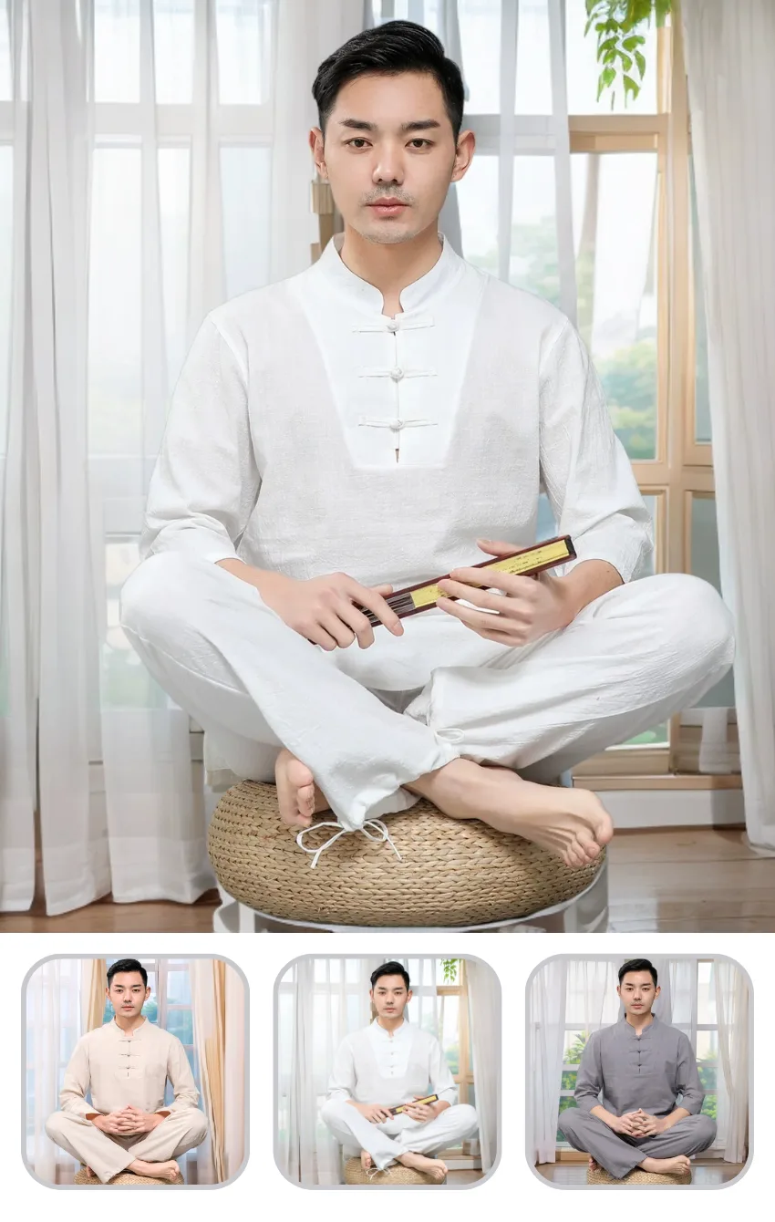 phap-phuc-dai-loan-3-nut 1 Asian man in a white traditional outfit sits cross‑legged on a woven cushion, holding a wooden scroll in a bright room with sheer curtains.