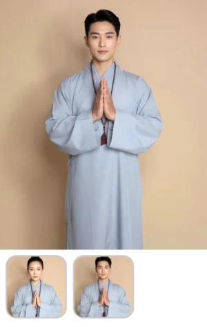 Pháp Phục Young man in light blue traditional robes stands against a beige backdrop hands pressed together in prayer wearing a bead necklace