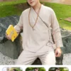 Pháp Phục Person in a beige traditional outfit and glasses sits on a stone ledge in a park holding a yellow book titled Detox
