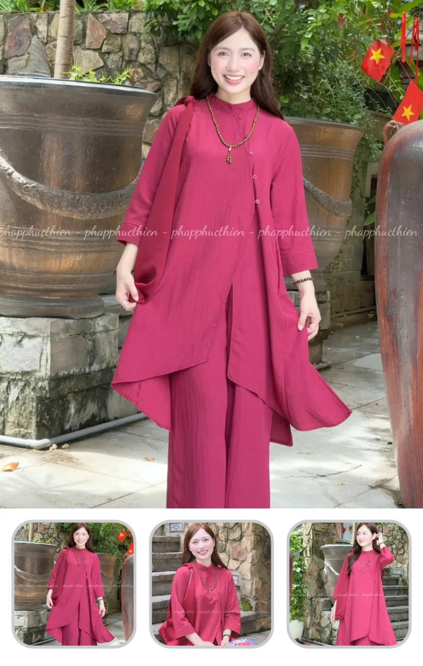 phap-phuc-tay-tang Smiling woman in a magenta tunic and wide-legged pants posing outdoors among large decorative pots and green plants, with small red flags in the background.