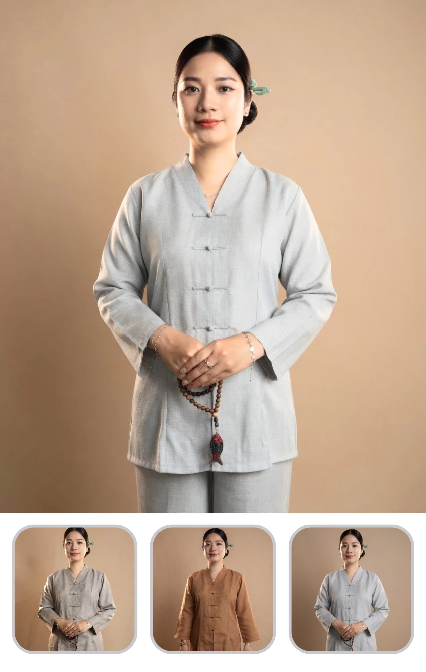 Portrait of a woman in a light gray traditional tang suit, hands clasped with wooden mala beads.