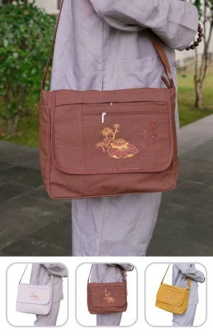 Pháp Phục Brown crossbody bag with embroidered floral design worn by a person in a light gray outfit shown from the side
