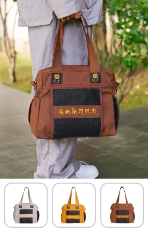 Pháp Phục Brown tote bag with black mesh pocket and yellow embroidery held by a person outdoors